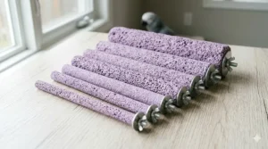 A photorealistic, high-detail 4K photograph displaying a side-by-side variety of multiple purple pumice perches for birds in different diameters, suitable for small to large species, arranged on a textured wooden surface.